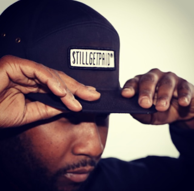 The iconic red trucker stillgetpaid branded hat